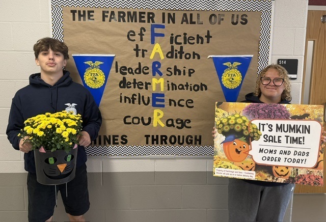 students holding mumkin advertisements