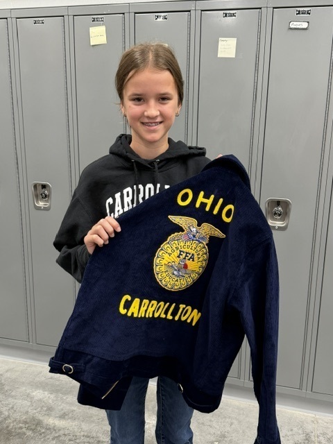 student receiving their jacket