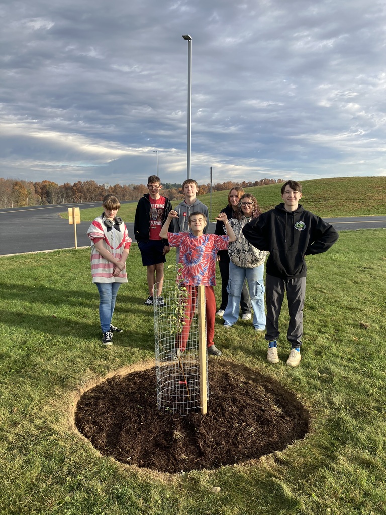 Kids with tree that was just planted