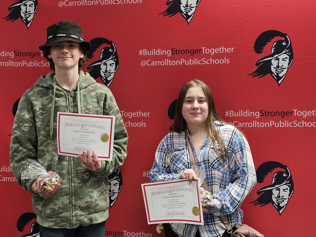 photo of Aaron Churchill and Amelia Kirkland in front of the Cavalier branding board
