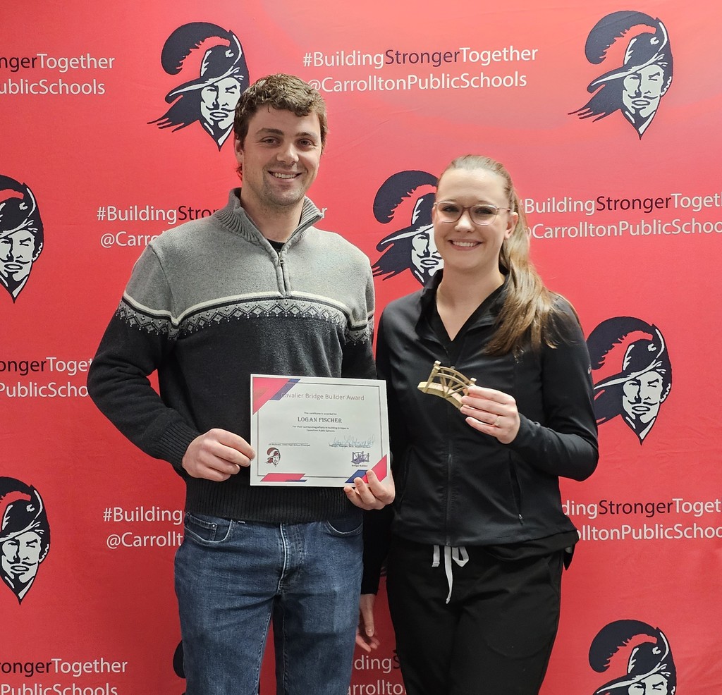 Two people stand smiling in front of a red CPS step-and-repeat backdrop with the Cavalier logo and the hashtag #BuildingStrongerTogether. On the left, a man holds a Cavalier Bridge Builder Award certificate. On the right, a woman holds a small bridge-shaped award.