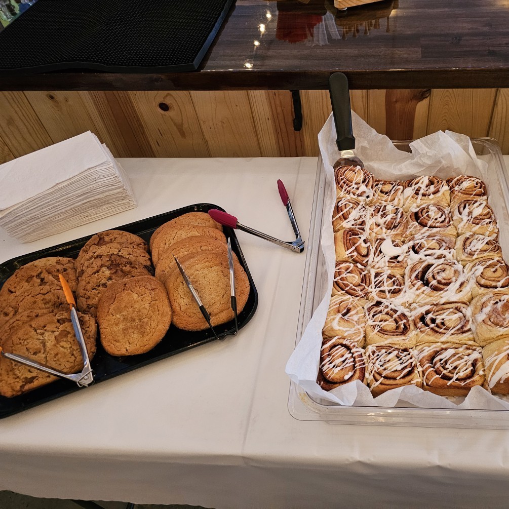cookies and cinnamon rolls displayed wity plates