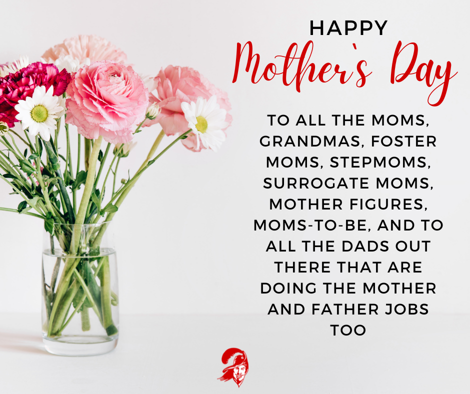 A clear glass vase filled with pink and white flowers sits on a white surface against a light background. To the right, the text reads: "Happy Mother’s Day. To all the moms, grandmas, foster moms, stepmoms, surrogate moms, mother figures, moms-to-be, and to all the dads out there that are doing the mother and father jobs too." A small red mascot logo is in the bottom right corner.