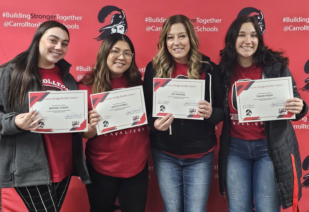 CES social worker and her interns holding up their Bridge Builder certificates