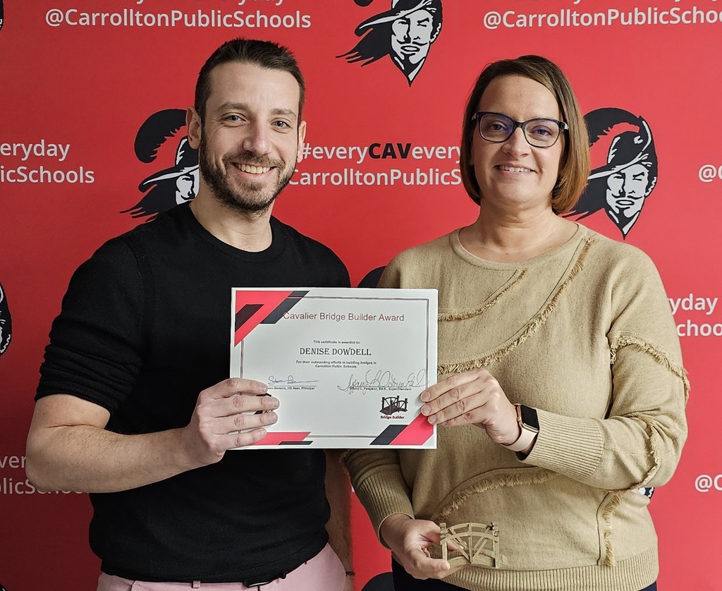 Mr. Benson giving Ms. Dowdell the Bridge Builder Award