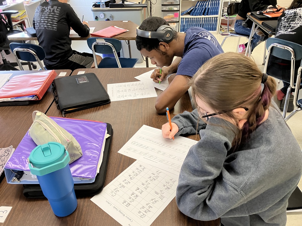 11th grade students practice writing in cursive