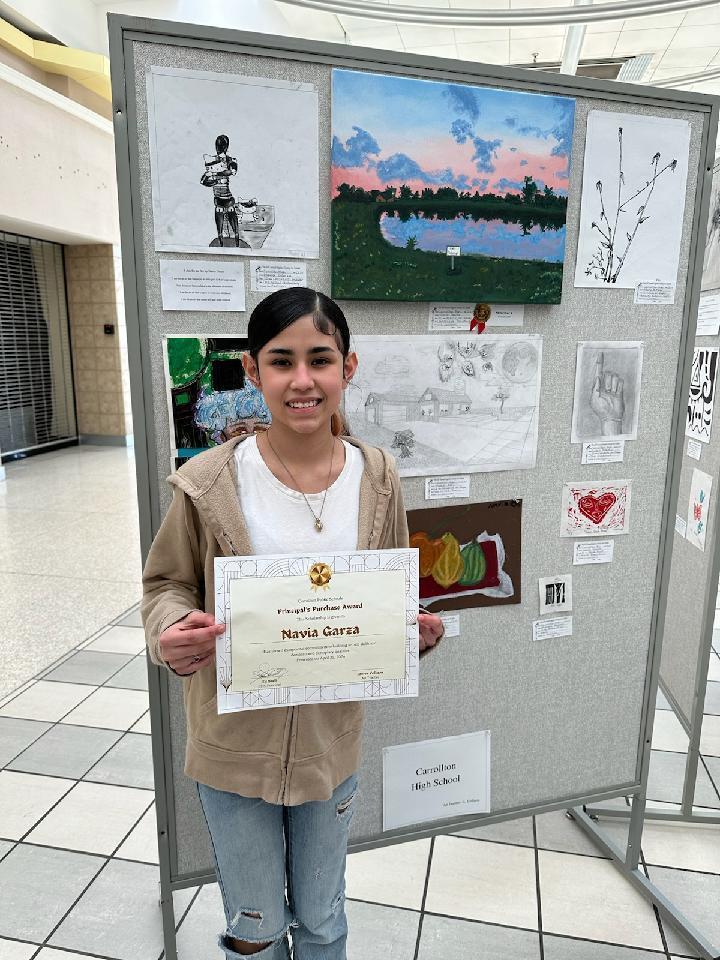 photo of student with award and artwork