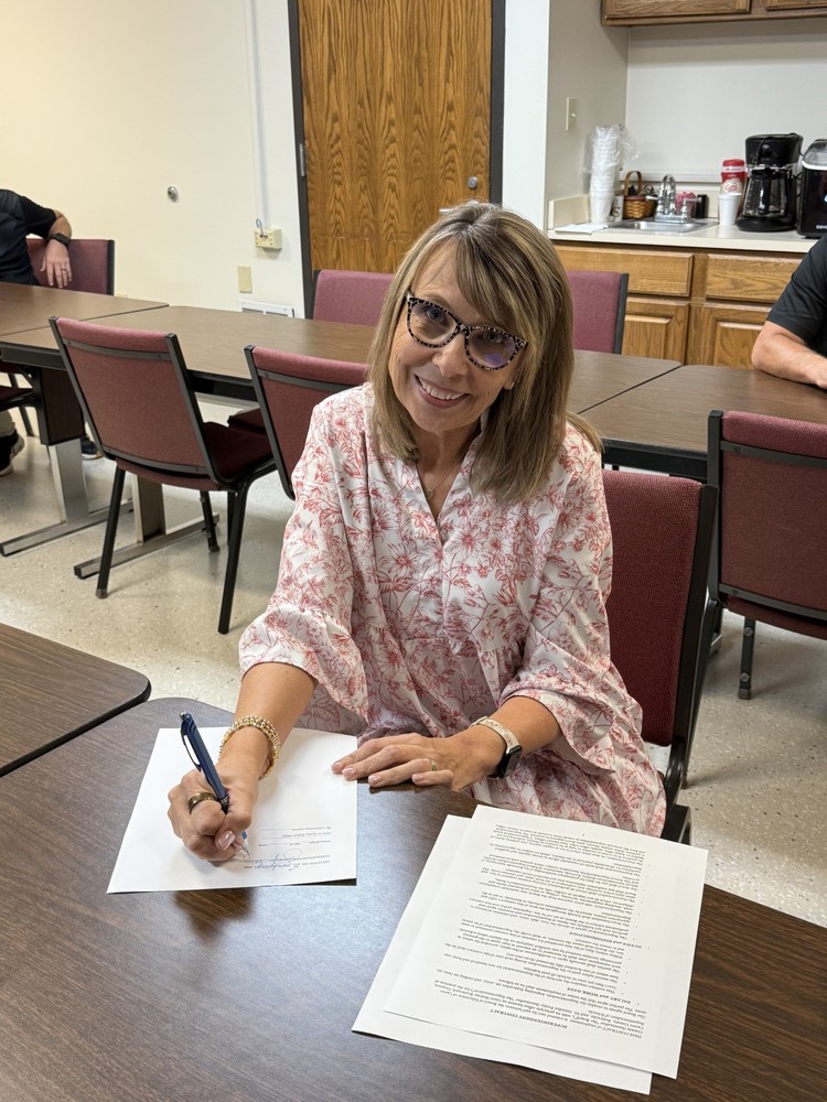 Dr. Fraley signing contract
