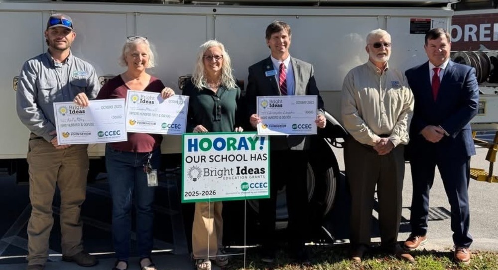 Picture of Bright Ideas grant recipients in front of the CCEC electric truck and MCES.
