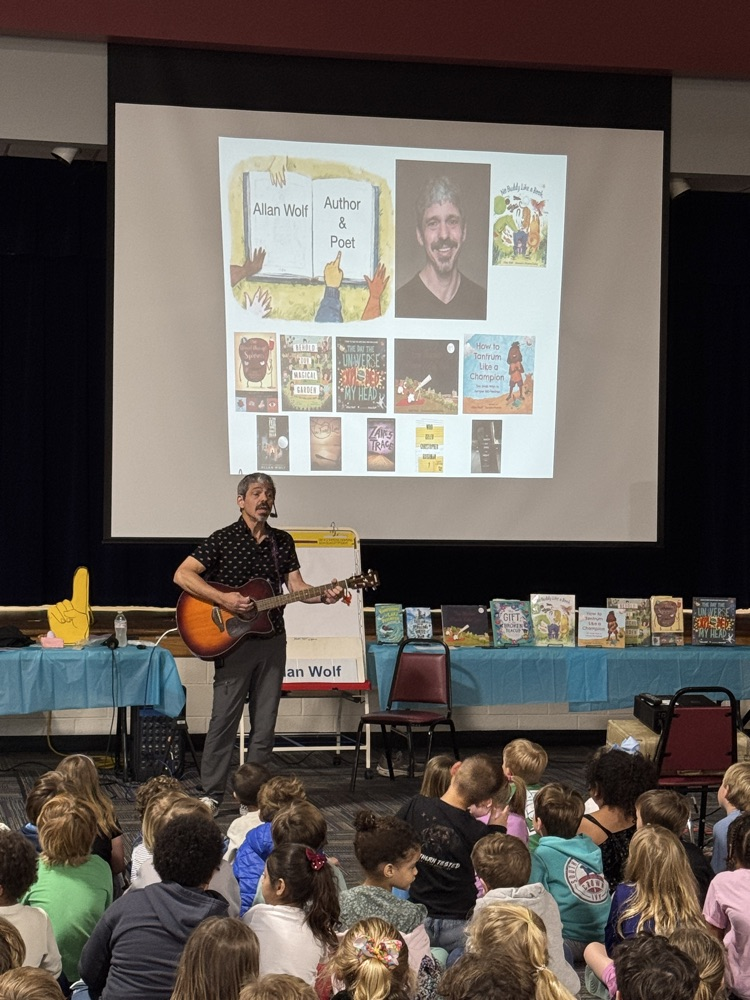 allan wolf in front of school children 