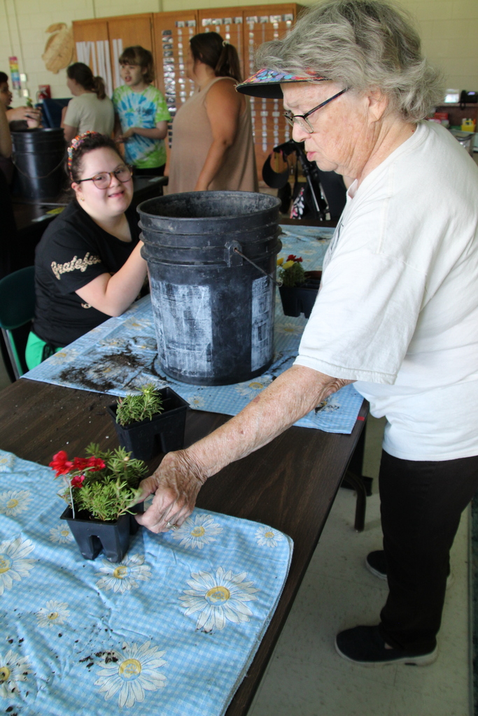 Liz Kappel reaches for a flower to plant.