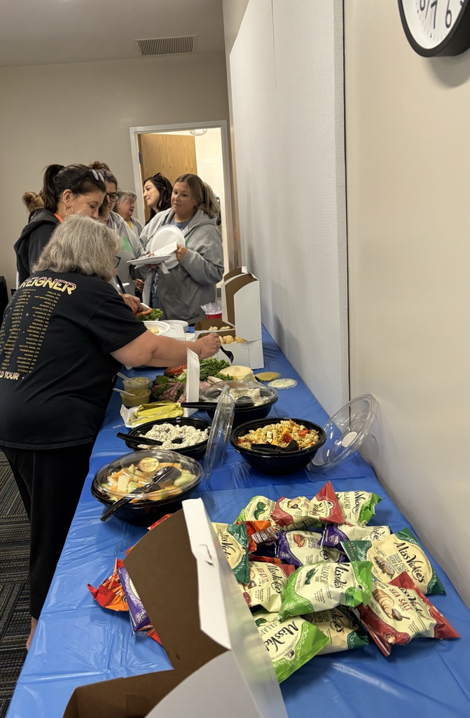 table of food with staff members serving their plates