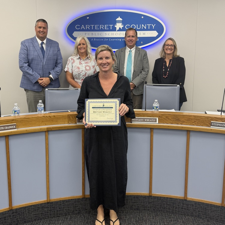 board member holding certificate