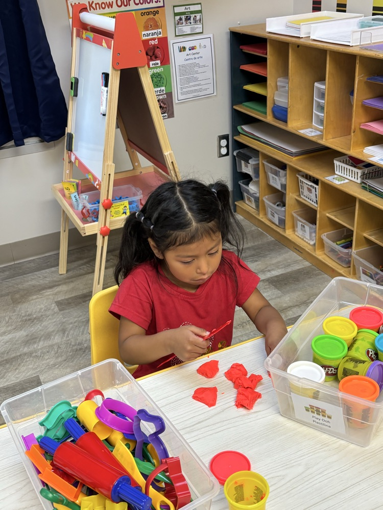 child playing with play dough 