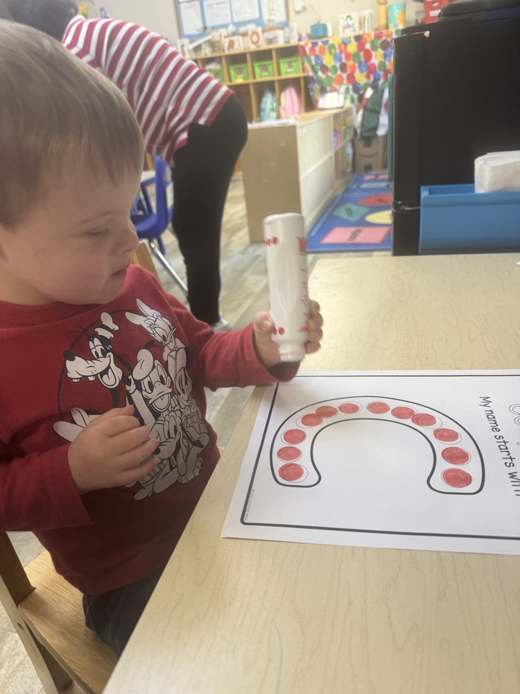 child using red dot marker 