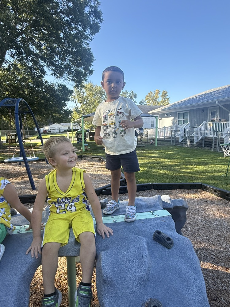 children on outdoor play equipment 