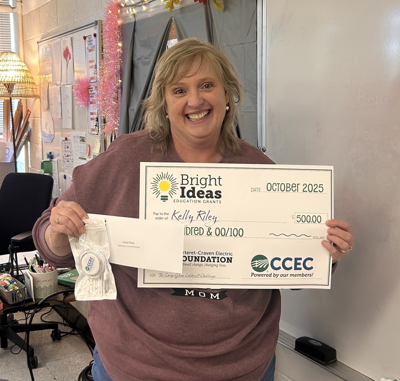 Picture of Mrs. Kelly Riley with her Bright Ideas grant check for her project.