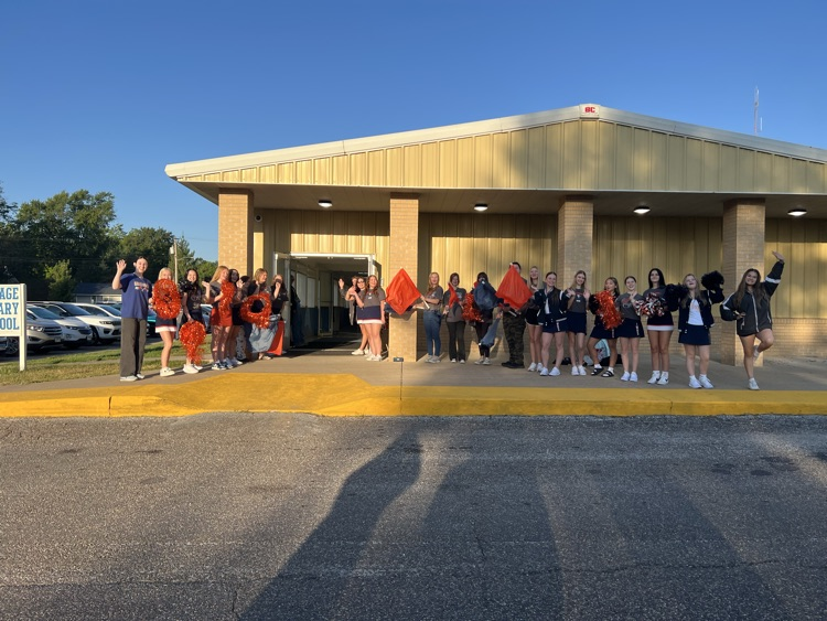 students standing in front of school 