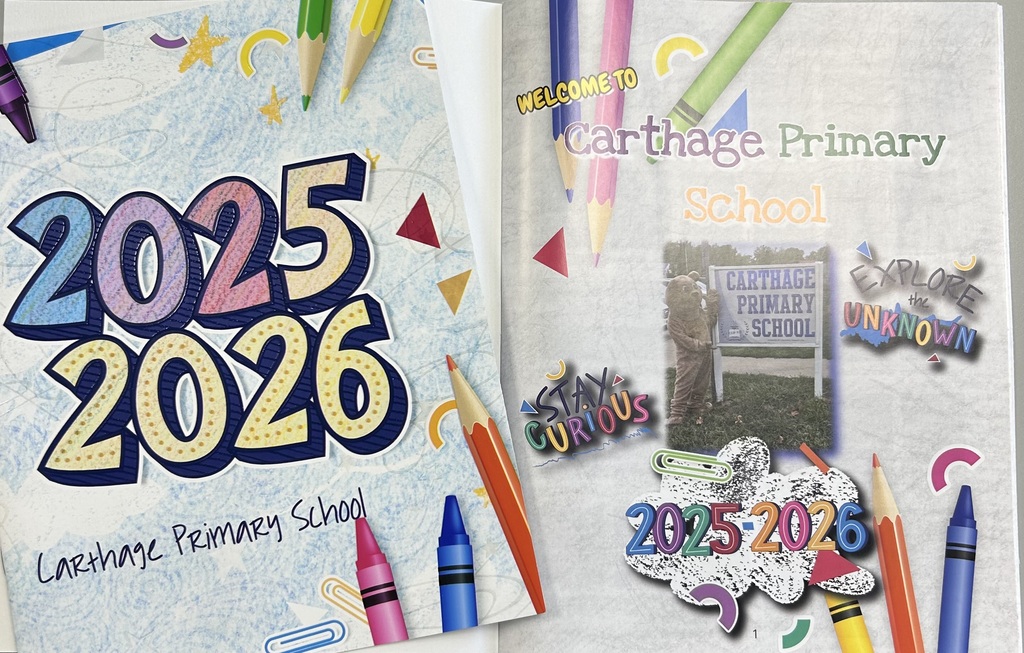 Photo of two Carthage Primary School yearbook cover options for the 2025-2026 school year. The left cover has large colorful “2025 2026” text with crayons, pencils, paper clips, stars, and the words “Carthage Primary School.” The right cover says “Welcome to Carthage Primary School” and includes a photo of the school sign, colorful pencils and crayons, and decorative phrases like “Stay Curious” and “Explore the Unknown.”