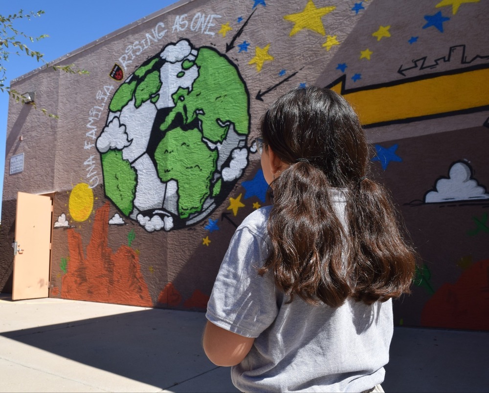 girl looking at mural at school campus_files