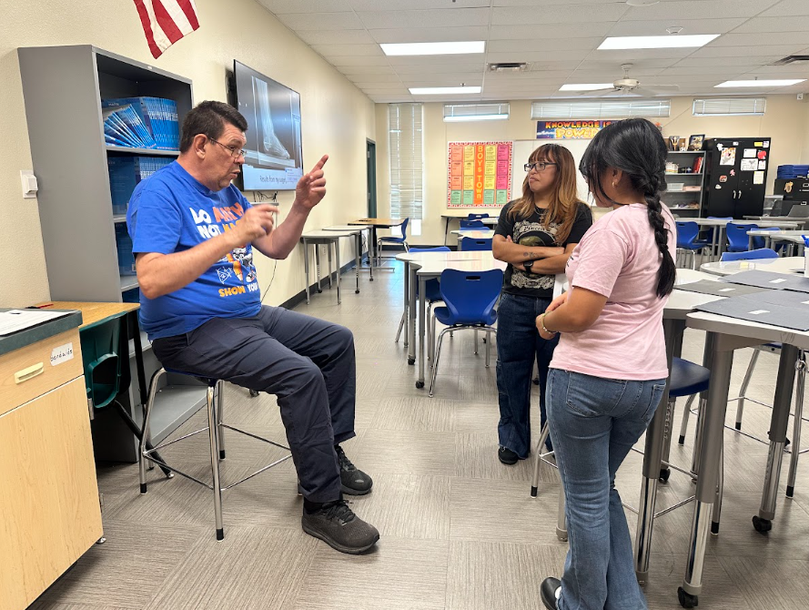 Techer talking to students in a classroom