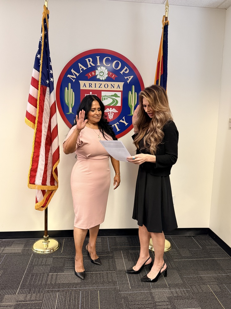 two women standing between flags