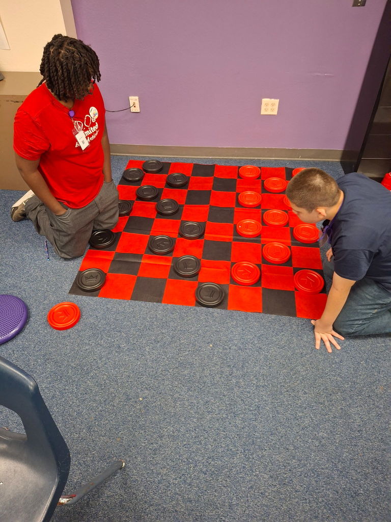 Students laughing and playing games during the Estrella Middle School July birthday celebration.