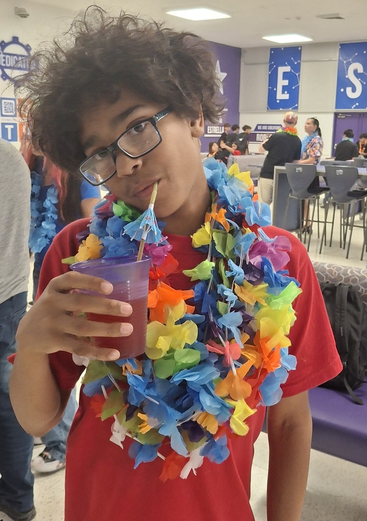 Students and staff smiling while enjoying the PBIS Luau activities.