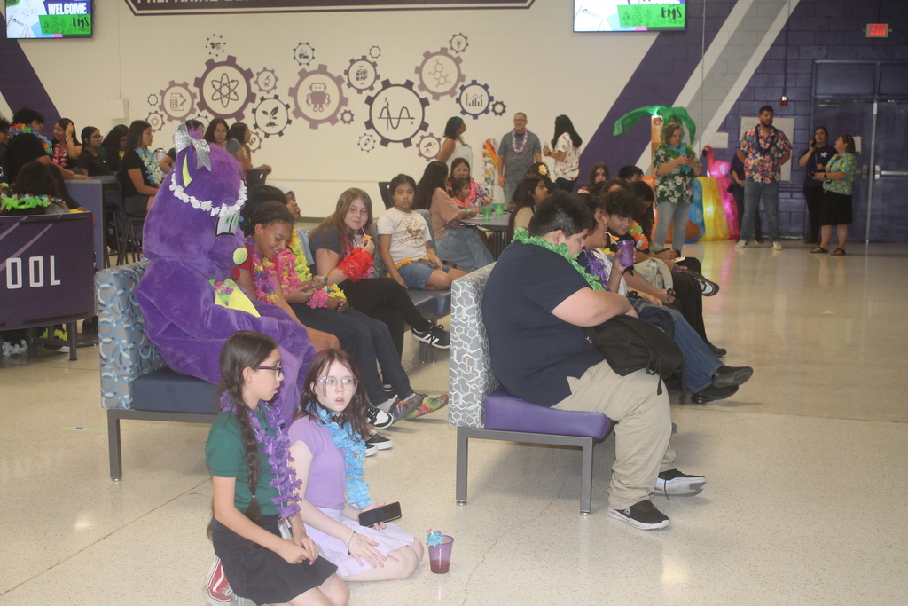 Students and staff smiling while enjoying the PBIS Luau activities.