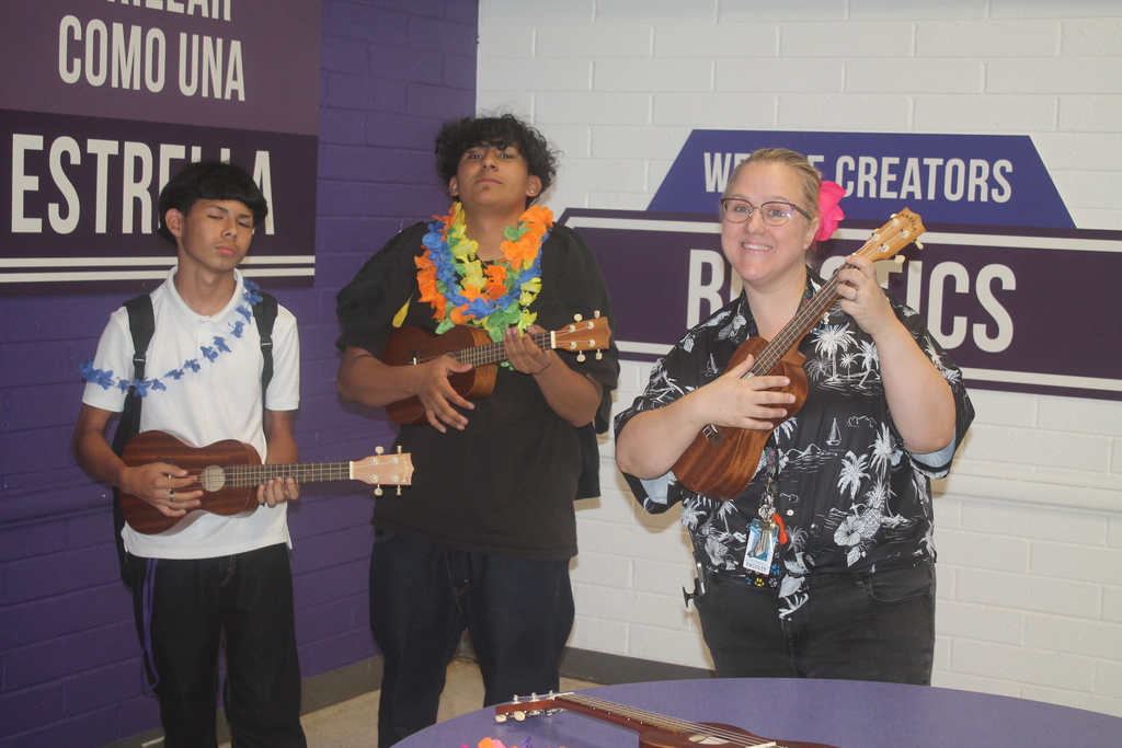 Student strumming a ukulele during the PBIS Luau event.