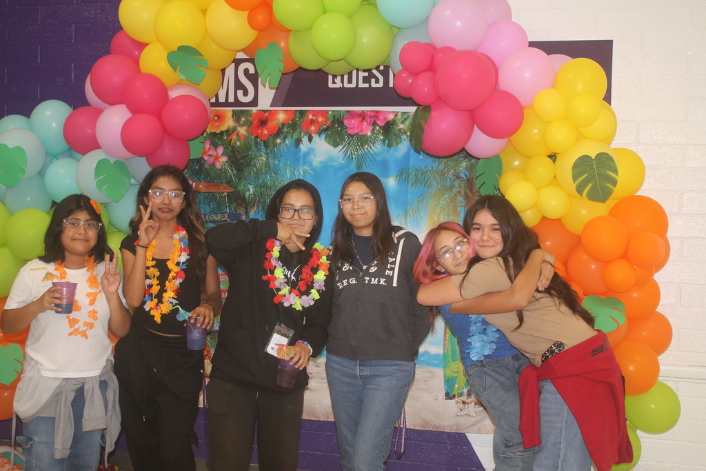 Students smiling while enjoying the PBIS Luau Photo Booth.