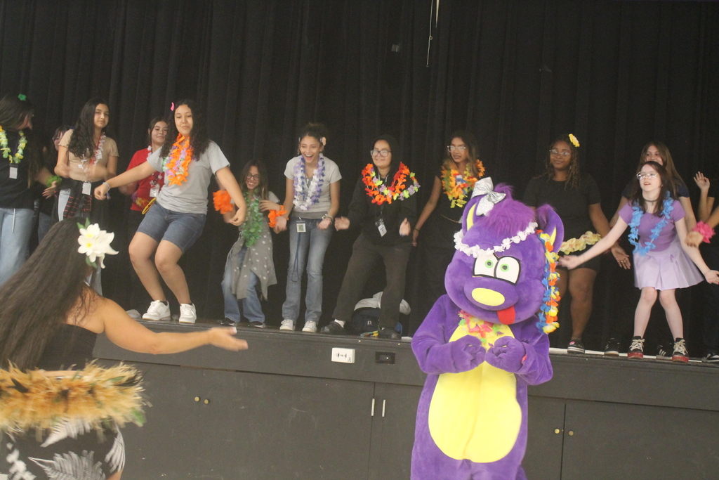 Students and staff smiling while enjoying the PBIS Luau activities.