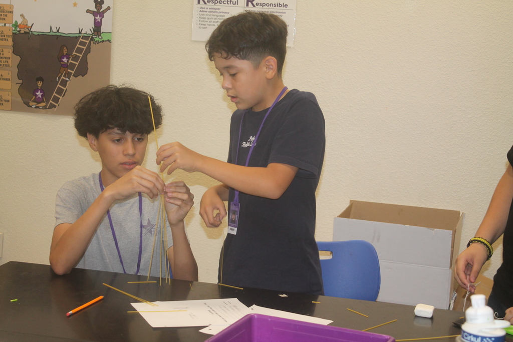 Students building marshmallow tower.