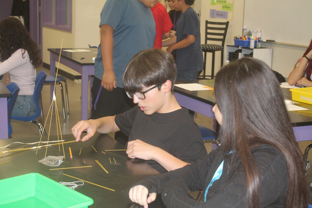 Students building marshmallow tower.