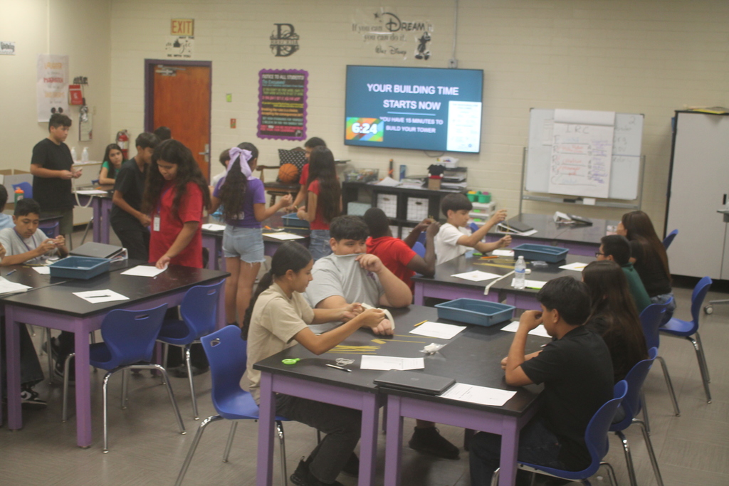 Students building marshmallow tower.