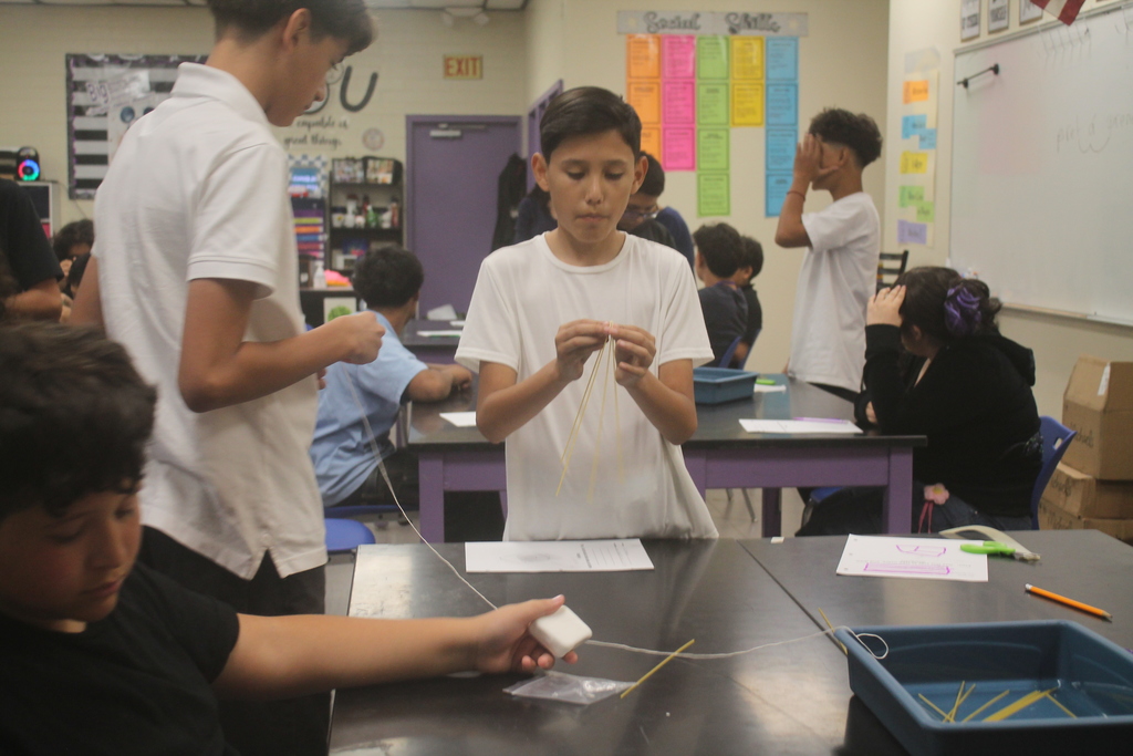 Students building marshmallow tower.
