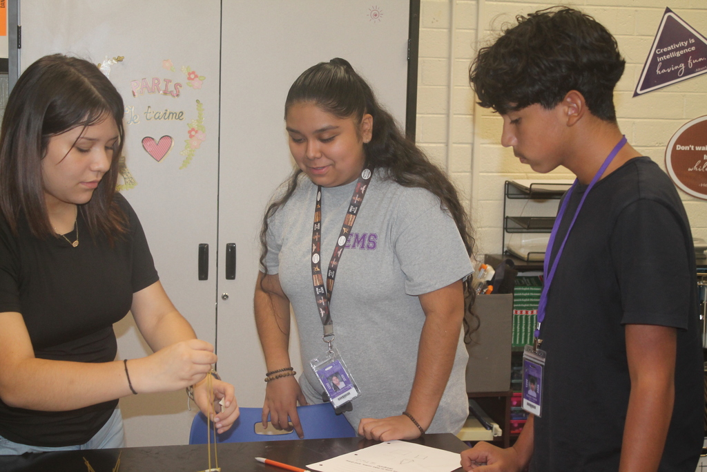 Students building marshmallow tower.