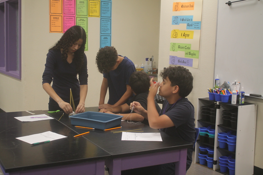 Students building marshmallow tower.