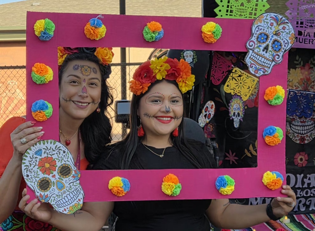 Two teachers dressed for Dia De Los Muertos