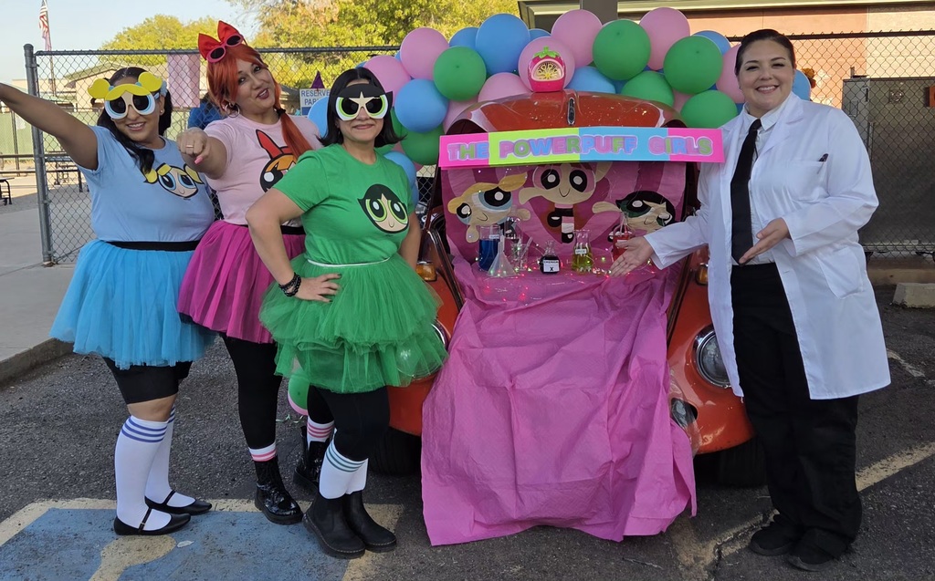 3 teachers dressed at the Power Puff Girls and 1 dressed as the professor