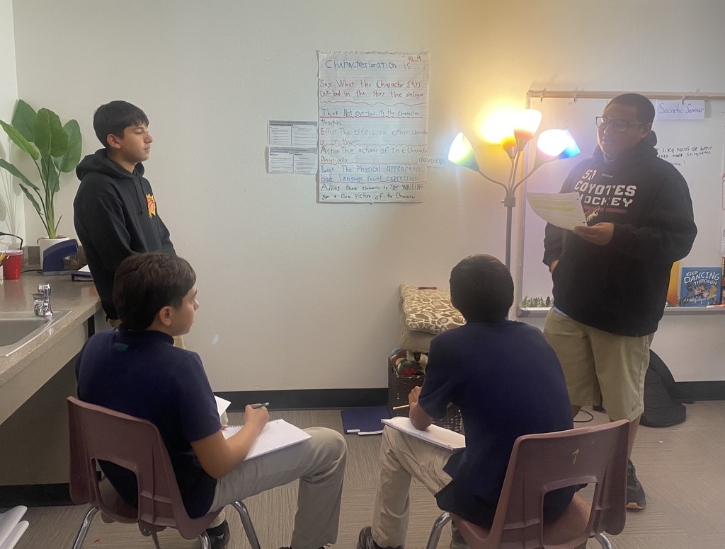 students listen as another student shares standards. 