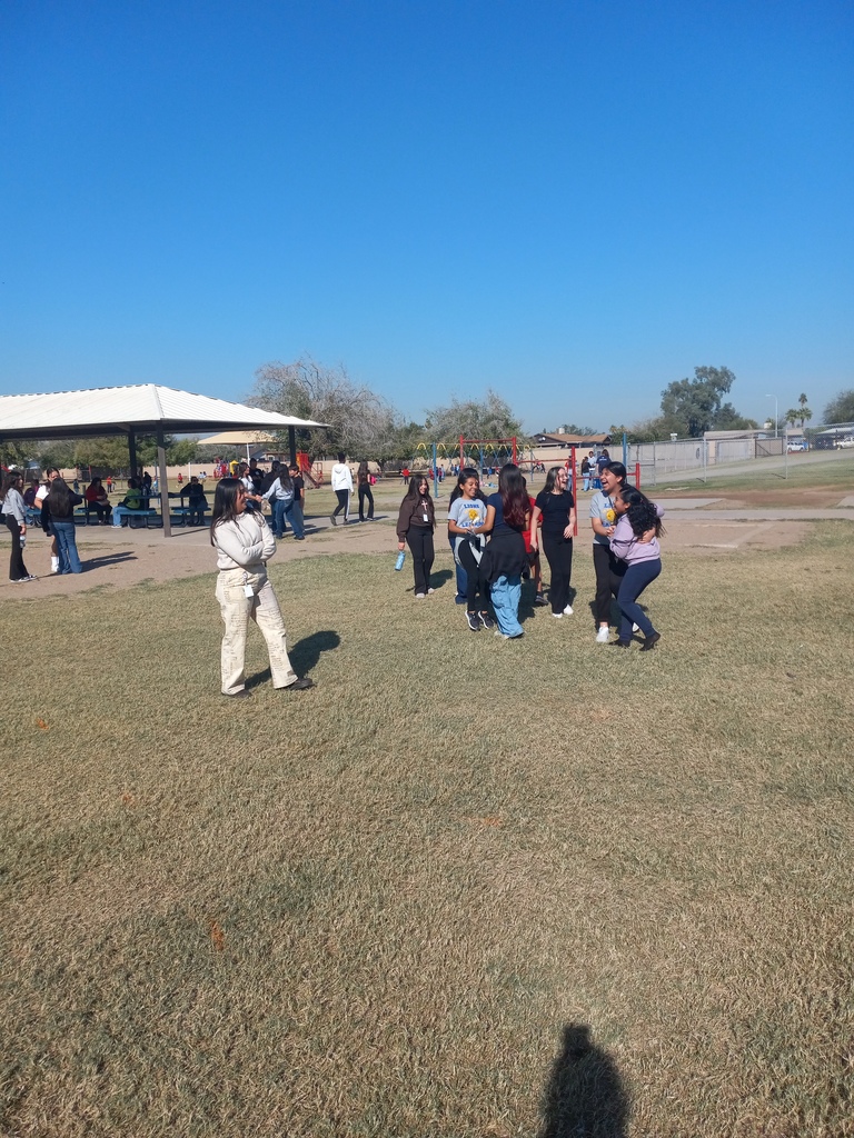 Group of girls laughing with their teacher