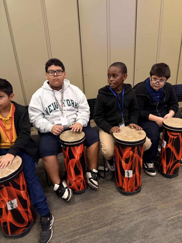 students hitting drums