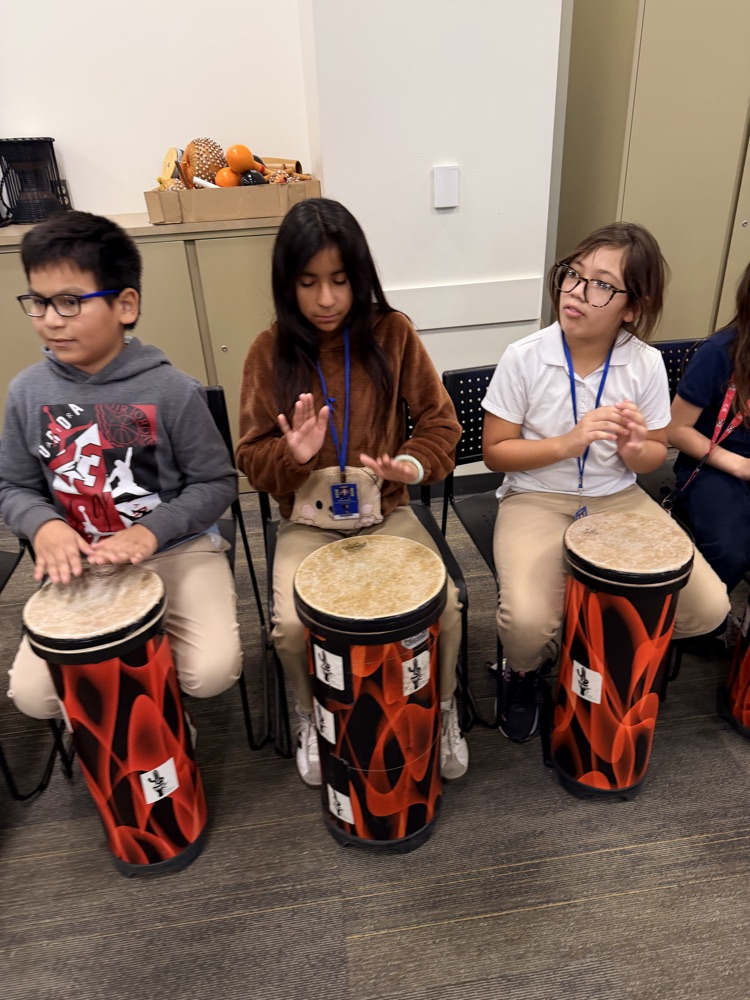 students hitting drums