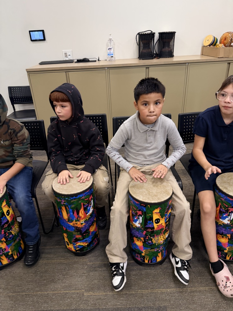 students hitting drums