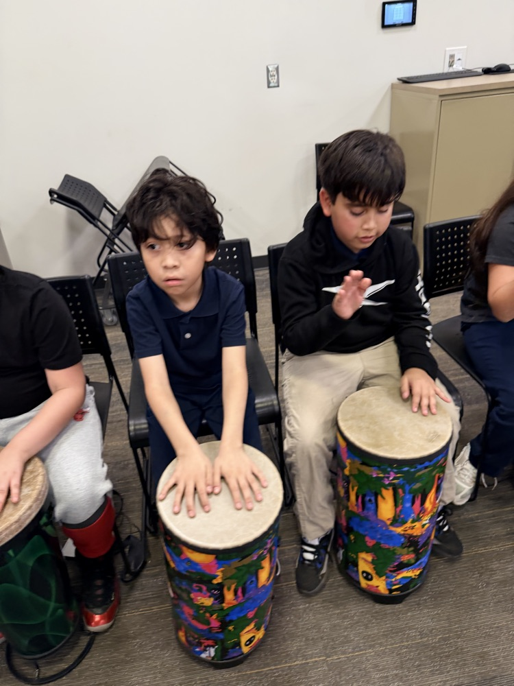 students hitting drums