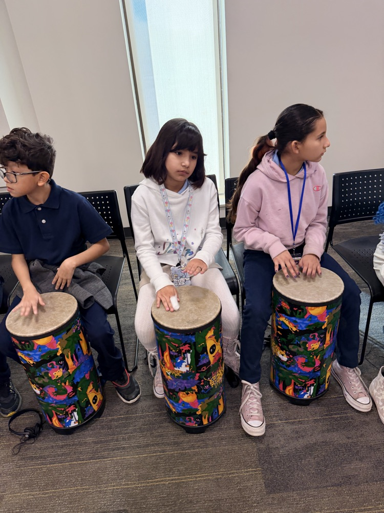 students hitting drums