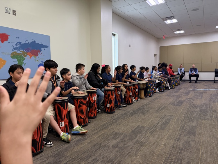 students hitting drums