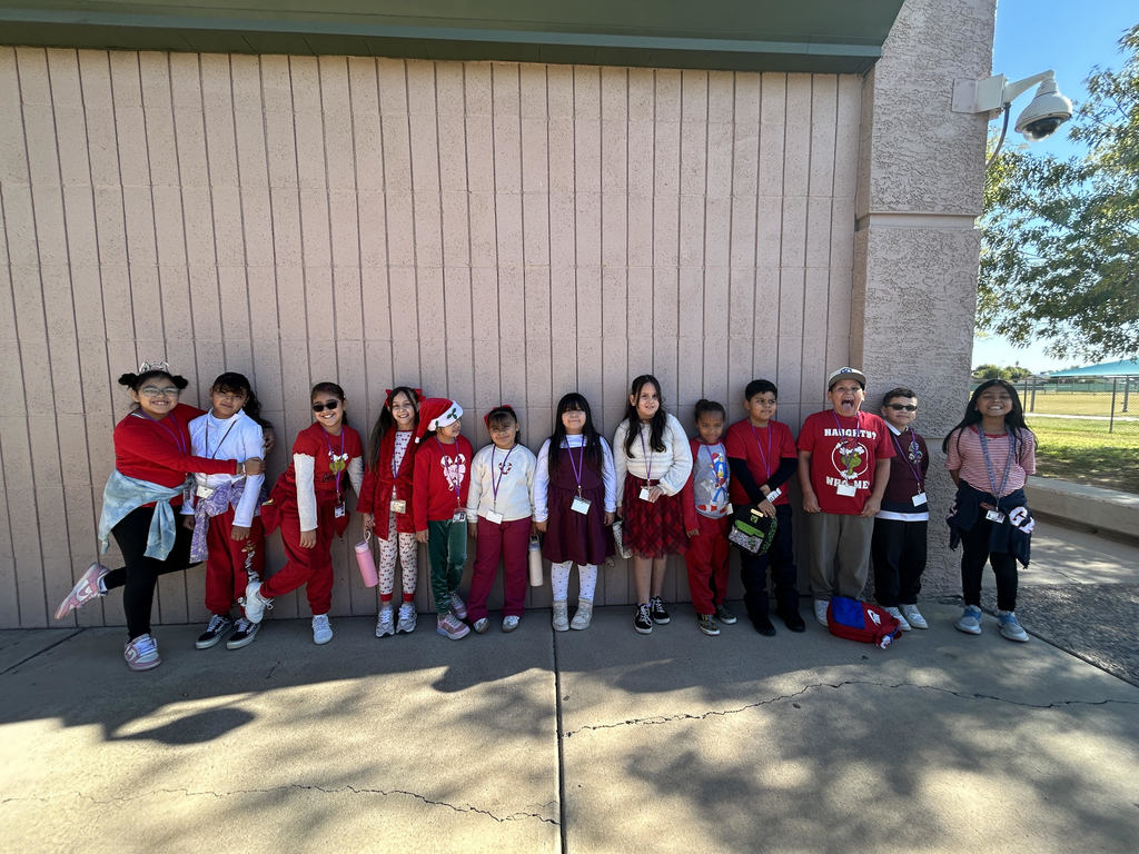 students lined up wearing red and white outfits