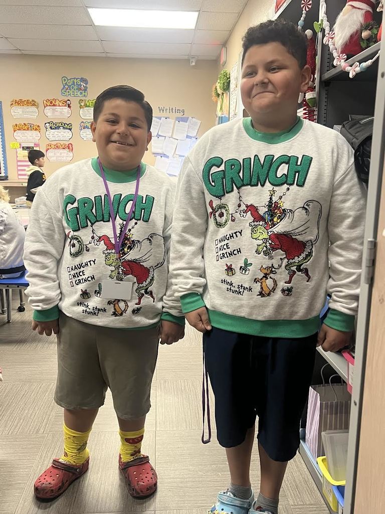students wearing matching grinch sweaters